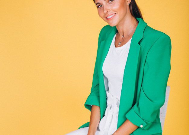 woman green jacket sitting chair yellow background 1303 10358 e1602526797555